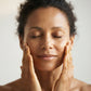 Application de L'Huile Éclat Sheatilly le soir sur le visage